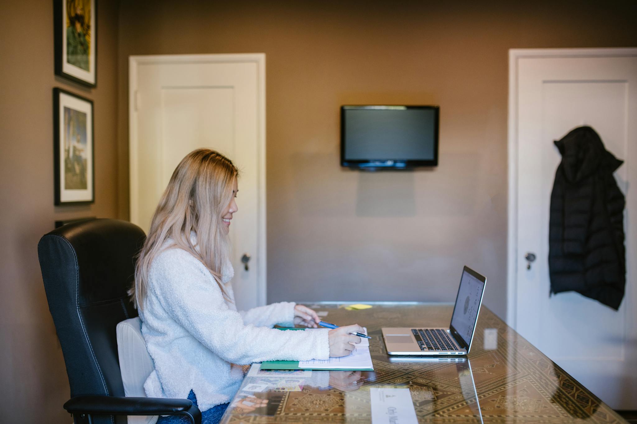 Woman focused on laptop during remote work from home.